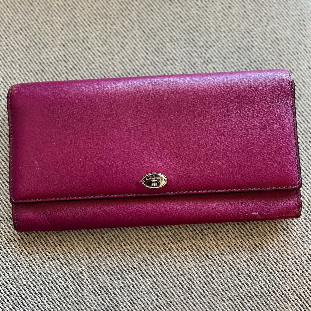 Lancel leather magenta long flap wallet with snap closure perfect for travel.